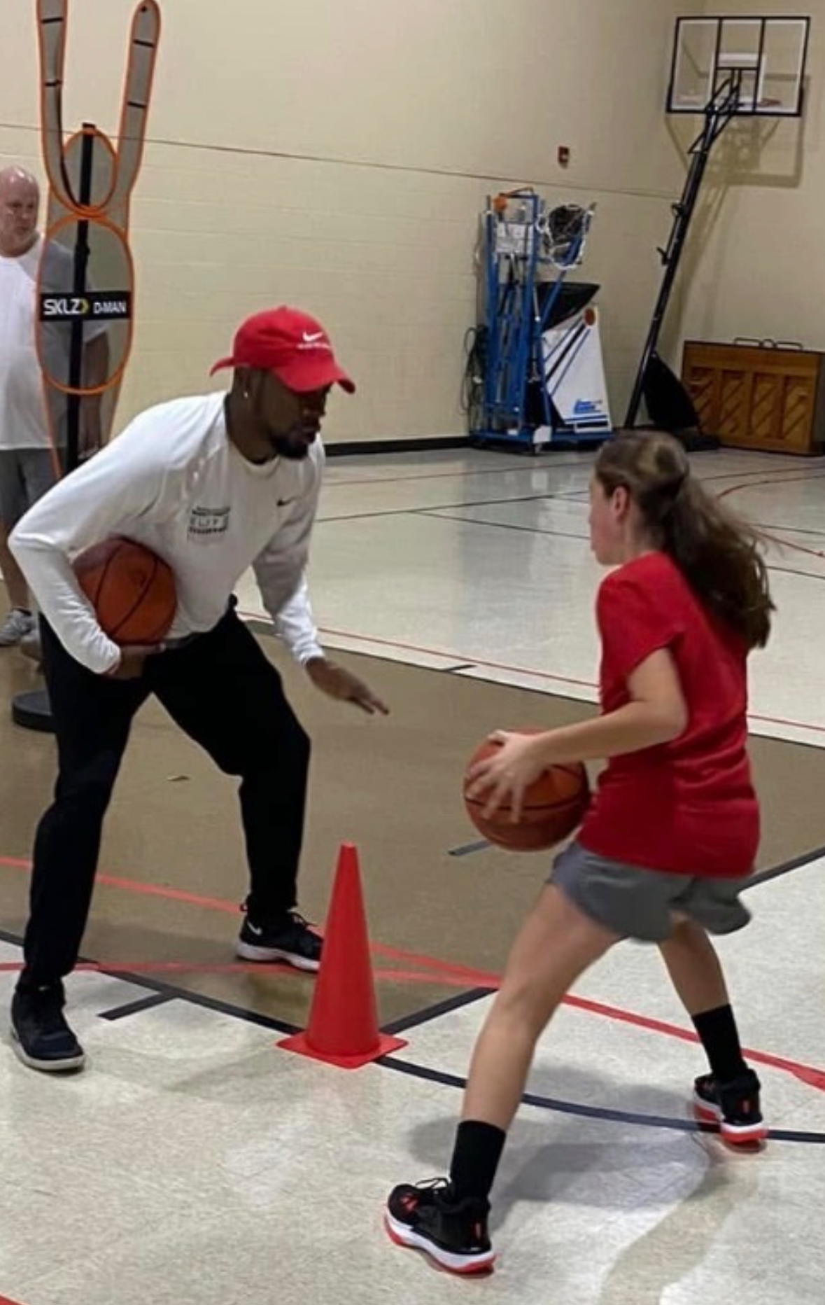 Coach Vinny giving one-on-one instruction to a young player